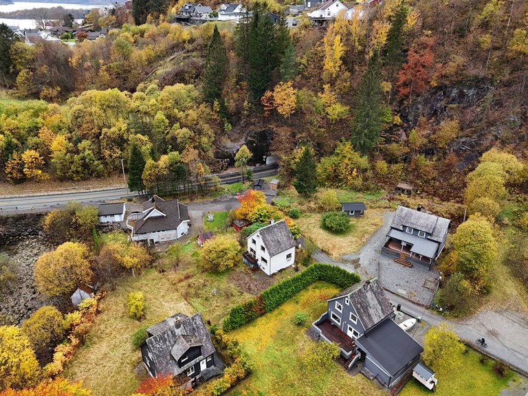 Bildet viser Vaksdal som er et av områdene der prosjektet planlegger å starte opp berg- og skredsikring av anleggsområdene først. Midt på bildet ser en dagens E16.